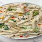 Make this delicious white sauce pasta at home by following simple steps
