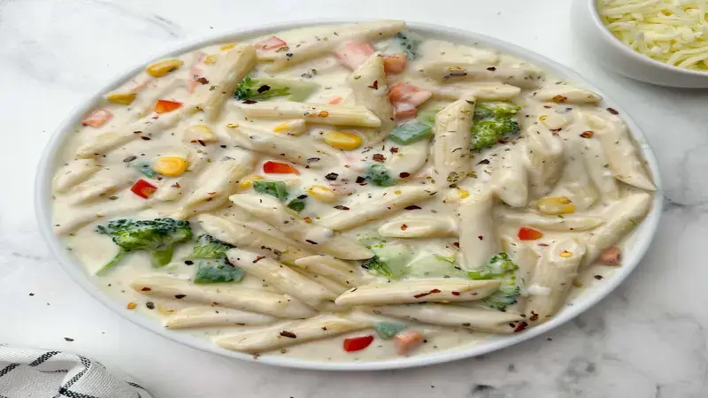Make this delicious white sauce pasta at home by following simple steps